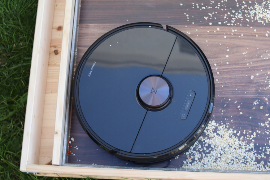 Roborock S6 vacuums along a skirting on a hard floor